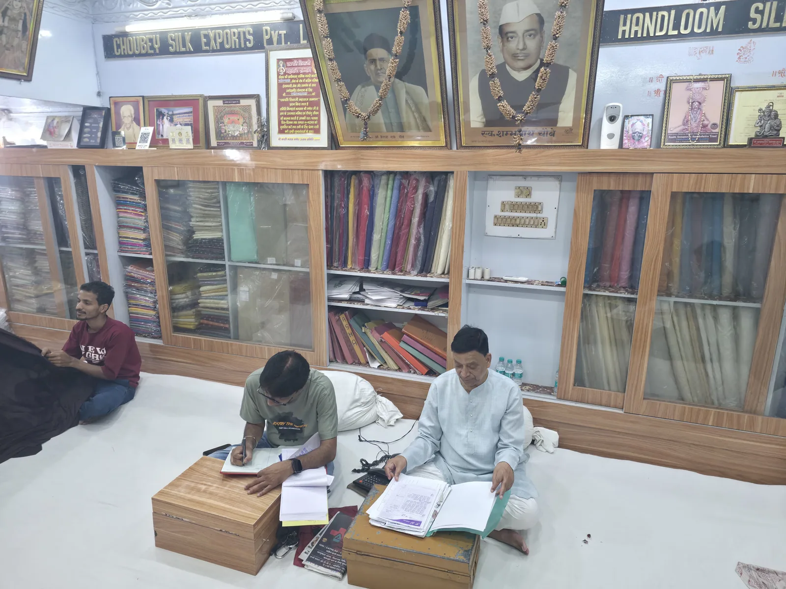 Choubey Silk team reviewing wholesale fabric orders in the Varanasi showroom